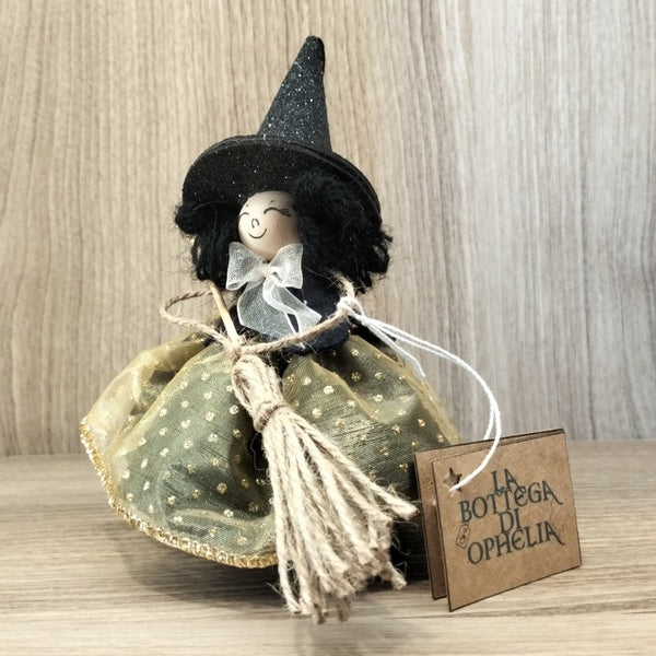 Bambolina streghetta capelli neri mantella nera fiocco bianco vestito dorato